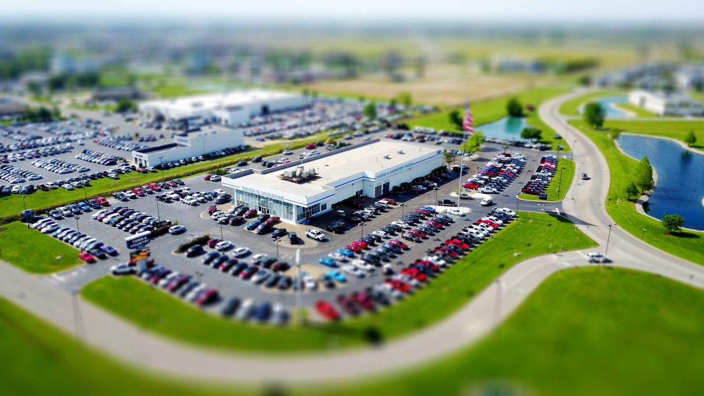 Aerial view of a dealership lot filled with cars